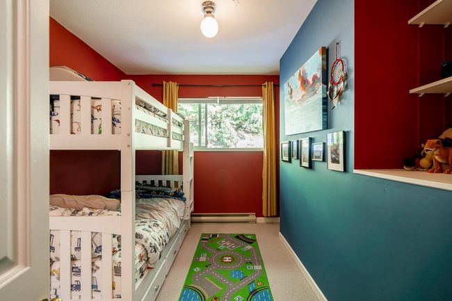 Carpeted bedroom featuring a baseboard heating unit and baseboards | Image 17