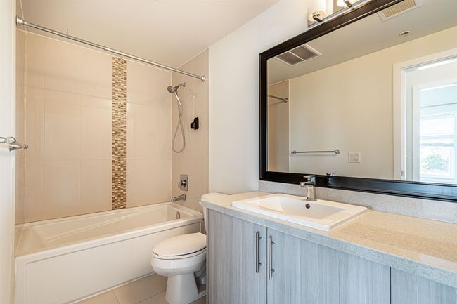 Bathroom with shower combination, vanity, and tile patterned flooring | Image 12