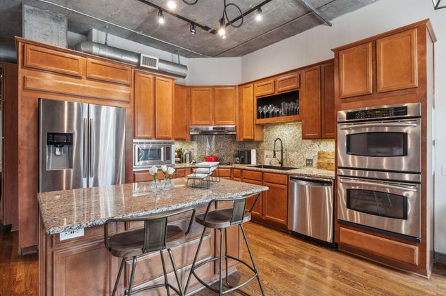 Cook and entertain in style with a kitchen boasting double ovens, microwave, refrigerator, and stainless steel appliances | Image 19