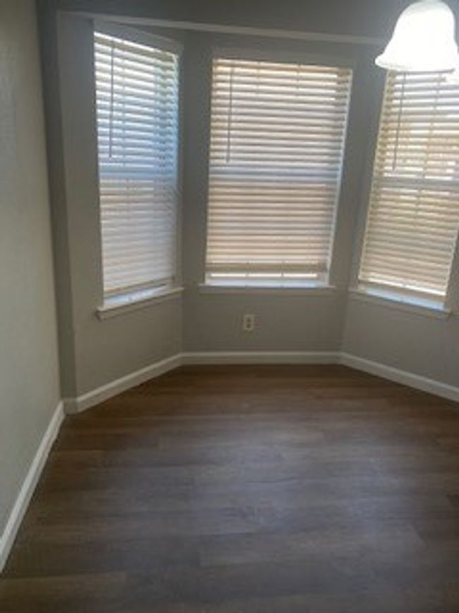 Spare room featuring dark wood-type flooring and baseboards | Image 6