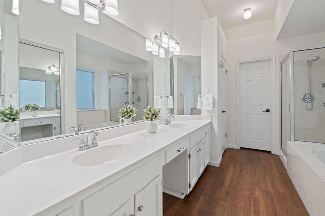 The spacious dual vanity offers plentry of room to stretch out with dressing table seating in the middle. | Image 22
