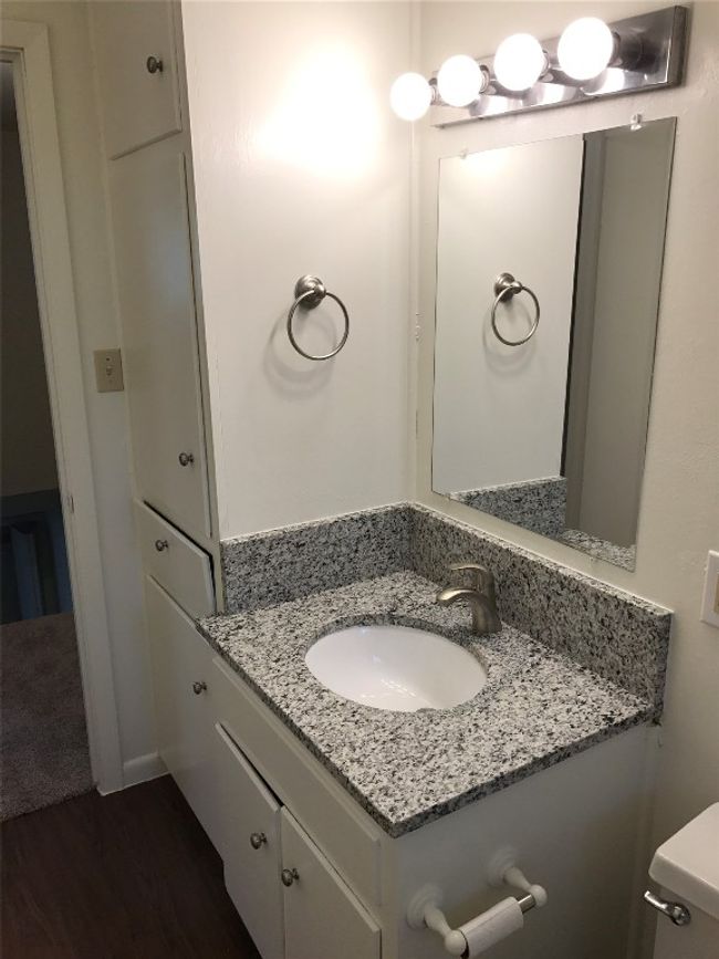 Half bathroom featuring toilet, wood finished floors, and vanity | Image 6