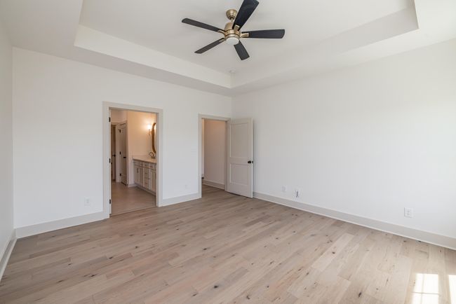 Primary Beddroom with Engineered Hardwood, Trey Ceiling, and Fan | Image 16