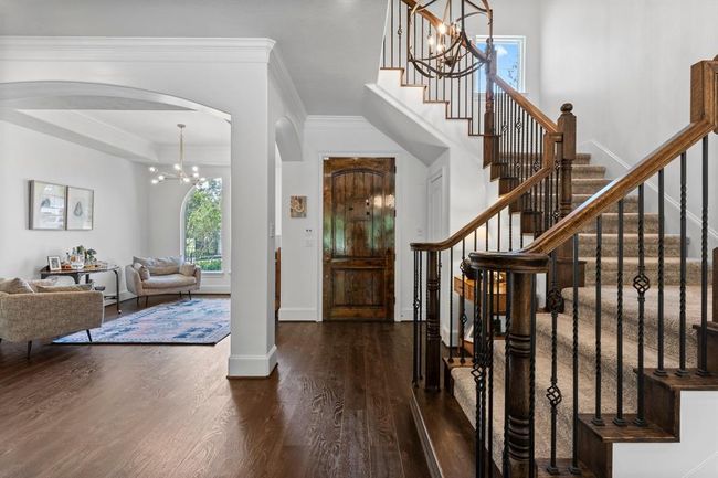 Staircase off the entry, look into a formal dining currently being used as a sitting area. | Image 6