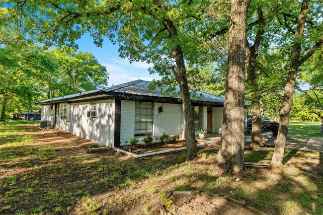 View of side of home featuring metal roof and central air condition unit | Image 35