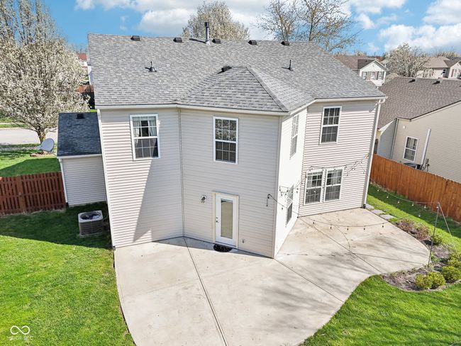 rear view of house with central AC, a patio, and a shingled roof | Image 85