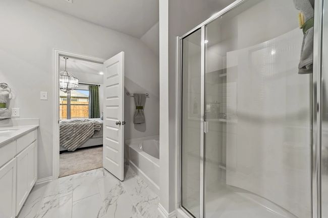 Ensuite bathroom with a shower stall, a bath, vanity, and marble finish flooring | Image 18
