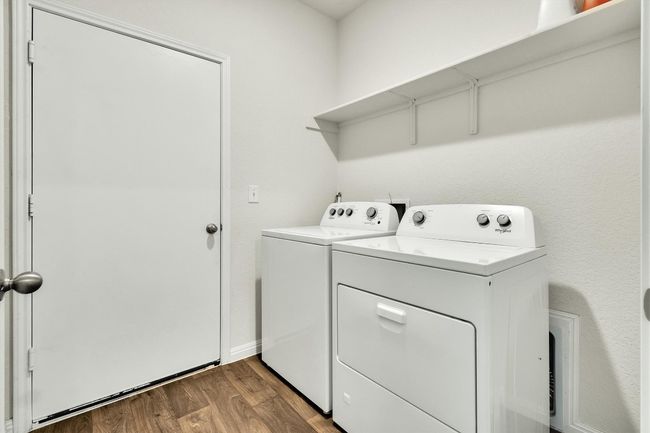 Washroom with washing machine and dryer, wood finished floors, and baseboards | Image 20