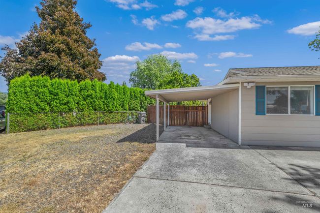 View of side of home featuring driveway and a carport | Image 33