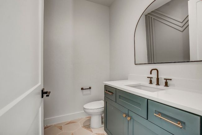 Bathroom with vanity, toilet, baseboards, and tile patterned floors | Image 10