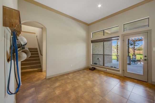 This is the breakfast room area, stairs lead to the media room. The hallway to the right leads to the 4th bedroom and 3rd full bath. | Image 16