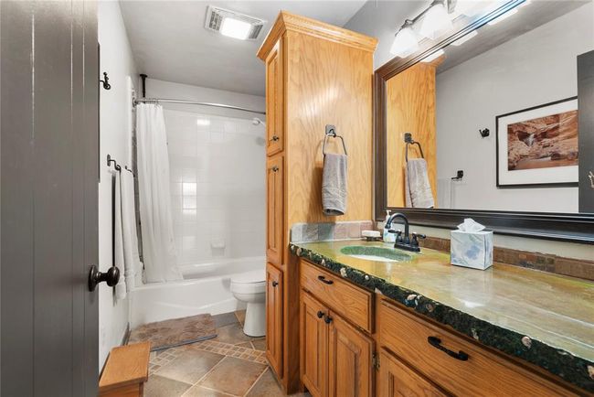 Full bath with visible vents, shower / bath combo with shower curtain, toilet, and vanity | Image 19