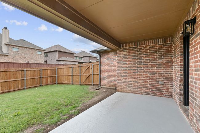 View of yard featuring a patio, a fenced backyard, and a residential view | Image 39