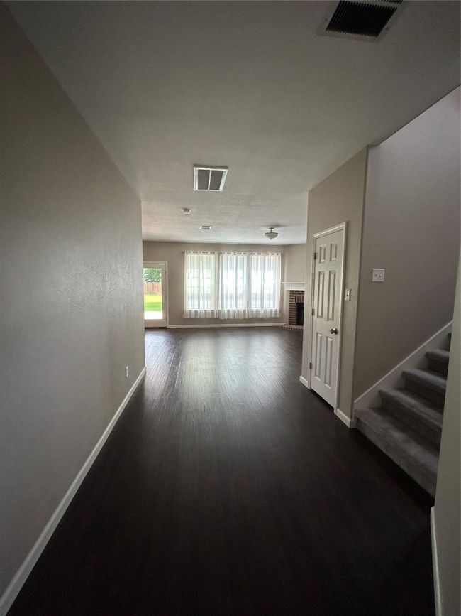 Hall with baseboards, plenty of natural light, and dark wood-style floors | Image 8