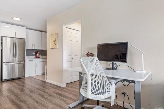 Home office with light wood-style flooring and baseboards | Image 5