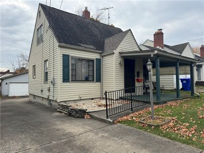 View of front of property featuring a covered porch and a garage | Image 3