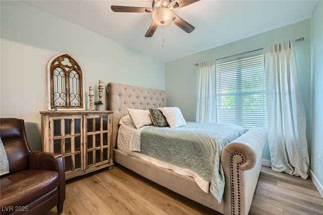 Bedroom featuring ceiling fan, lofted ceiling, and light wood finished floors | Image 12