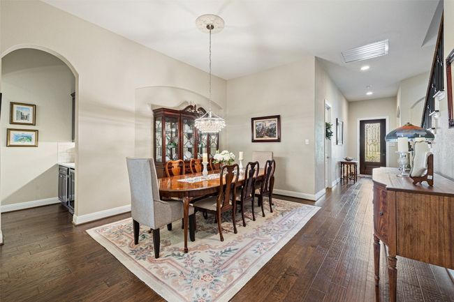 Formal Dining space with recessed lighting, chandelier, arched walkways, and dark hardwood finished floors | Image 4
