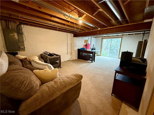 Basement with electric panel and carpet floors | Image 32