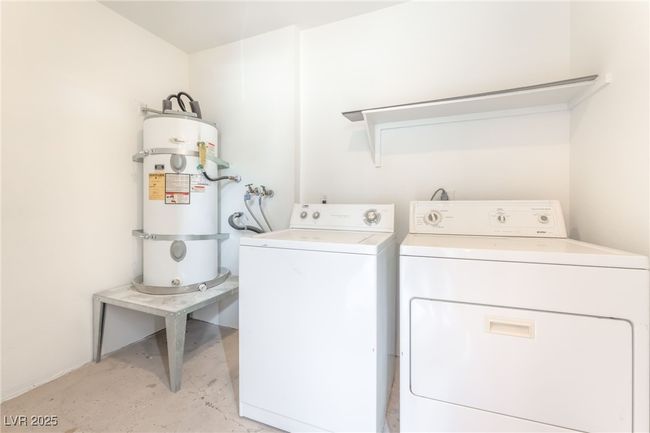 Laundry room with water heater and washing machine and dryer | Image 26