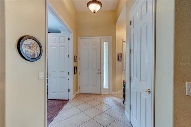 Front / Foyer entryway with office double doors to the left, hallway to the right 2nd bedroom and guest bathroom to the right, Hall closet on right | Image 12
