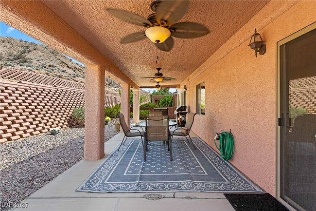 Fenced backyard featuring outdoor dining space, ceiling fan, a patio, and a grill | Image 41