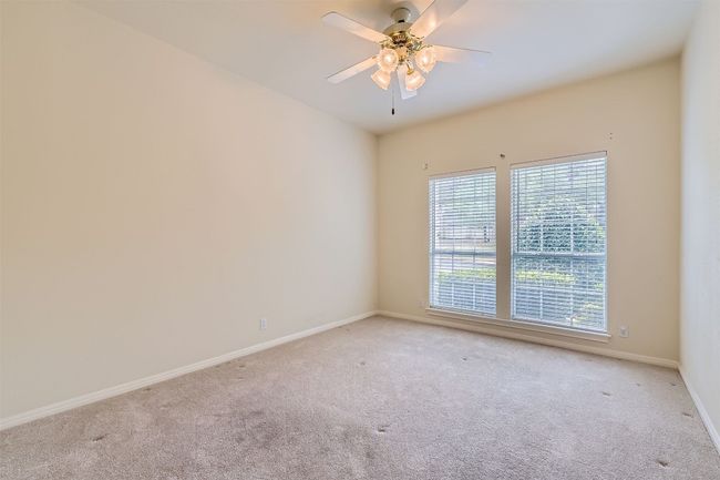 Secondary bedroom with carpet, ceiling fan and facing the front of the house | Image 22