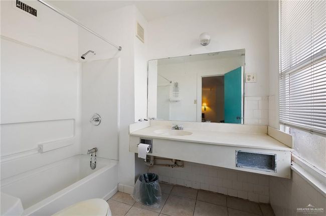 Full bath with tile patterned floors, visible vents, toilet, a sink, and shower / washtub combination | Image 21