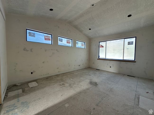 Spare room with lofted ceiling and a textured ceiling | Image 23