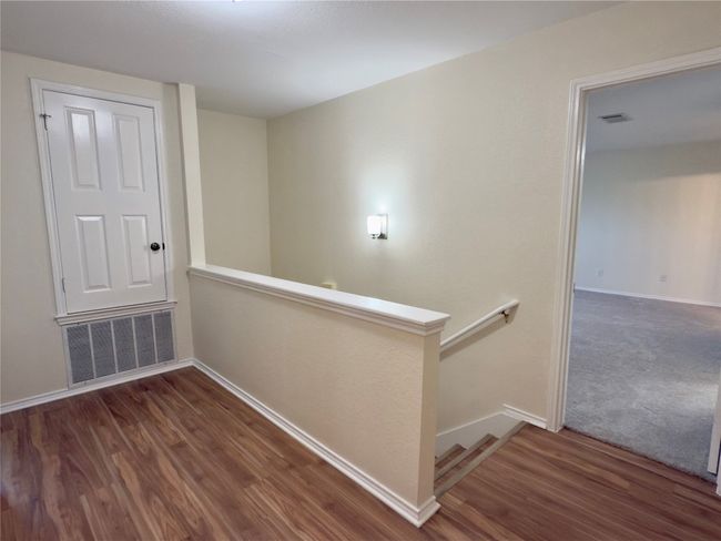 Corridor featuring an upstairs landing and wood finished floors | Image 18