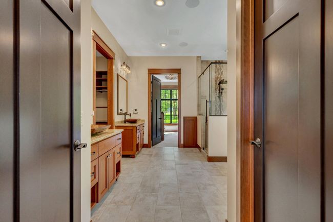 Primary bath designed as a spa-like retreat, featuring luxurious finishes, a soaking tub, and a serene atmosphere for ultimate relaxation. | Image 48