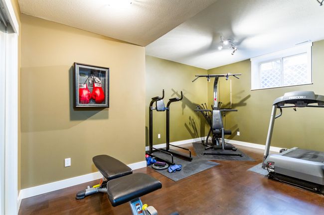 Workout room with baseboards and wood finished floors | Image 24