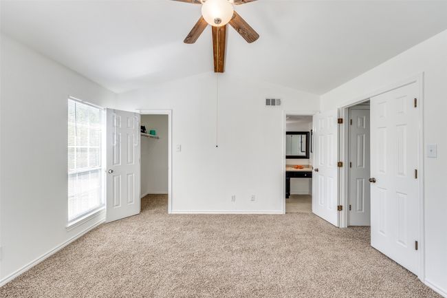 Primary bedroom has walk-in closst, ceiling fan, and great natural light. New carpeting installed throughout upstairs. | Image 11