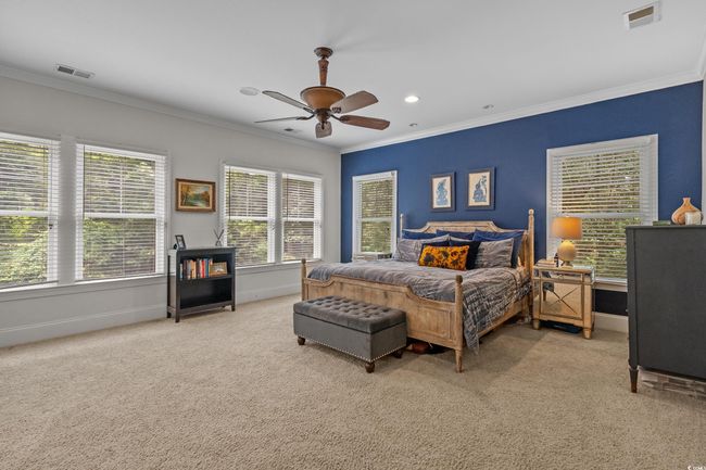 Bedroom featuring light colored carpet, ornamental molding, a ceiling fan, and recessed lighting | Image 25