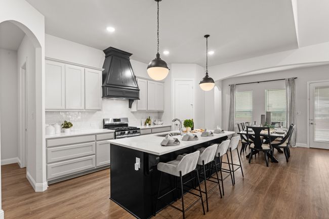 A view of the spacious island and dining. Love the pendant lights! | Image 15