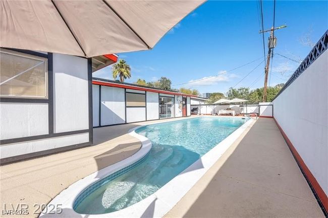 View of swimming pool with a patio area | Image 25