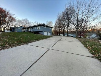 View of side of property featuring a garage and a lawn | Image 3