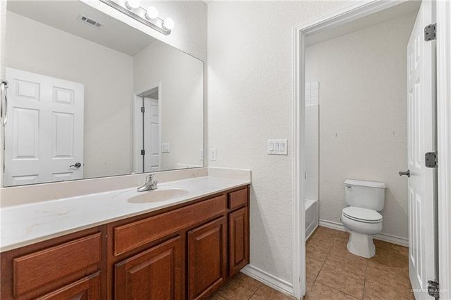 Full bathroom featuring vanity, tile patterned flooring, and shower / washtub combination | Image 31