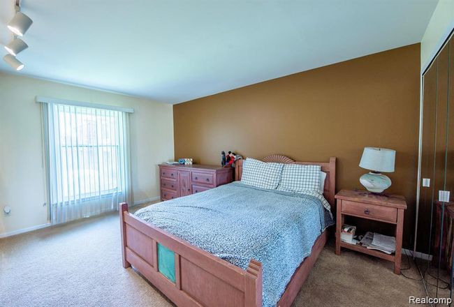 Bedroom with light carpet and a closet | Image 26