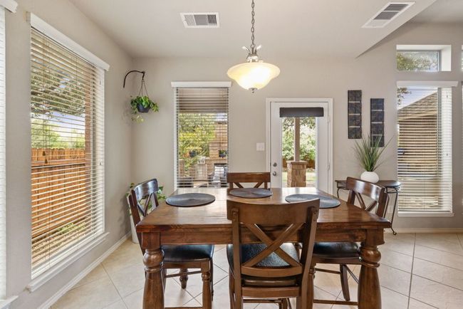 Dining area featuring light tile patterned floors | Image 11