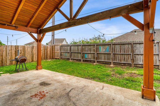 This charming A-frame covered patio impresses with its soaring ceiling, creating a grand atmosphere while offering ample shade for comfortable outdoor living. | Image 31