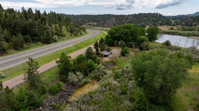 Aerial view of property and surrounding area featuring a heavily wooded area and a nearby body of water | Image 49