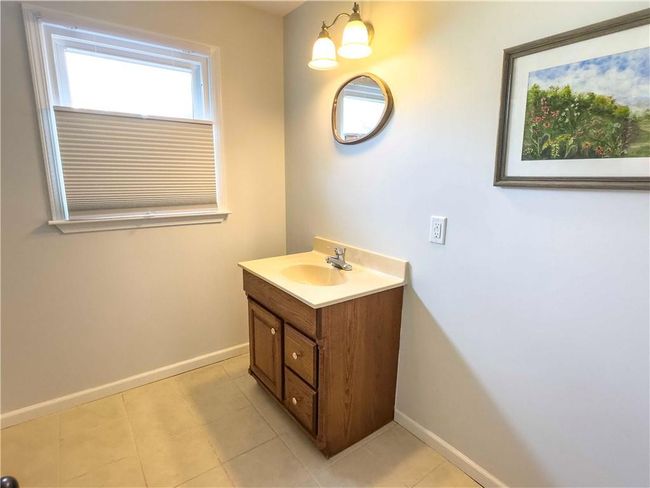 Bathroom with tile patterned flooring, vanity, and baseboards | Image 32