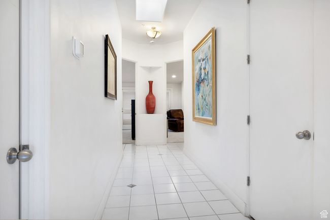 Corridor featuring baseboards and light tile patterned floors | Image 11