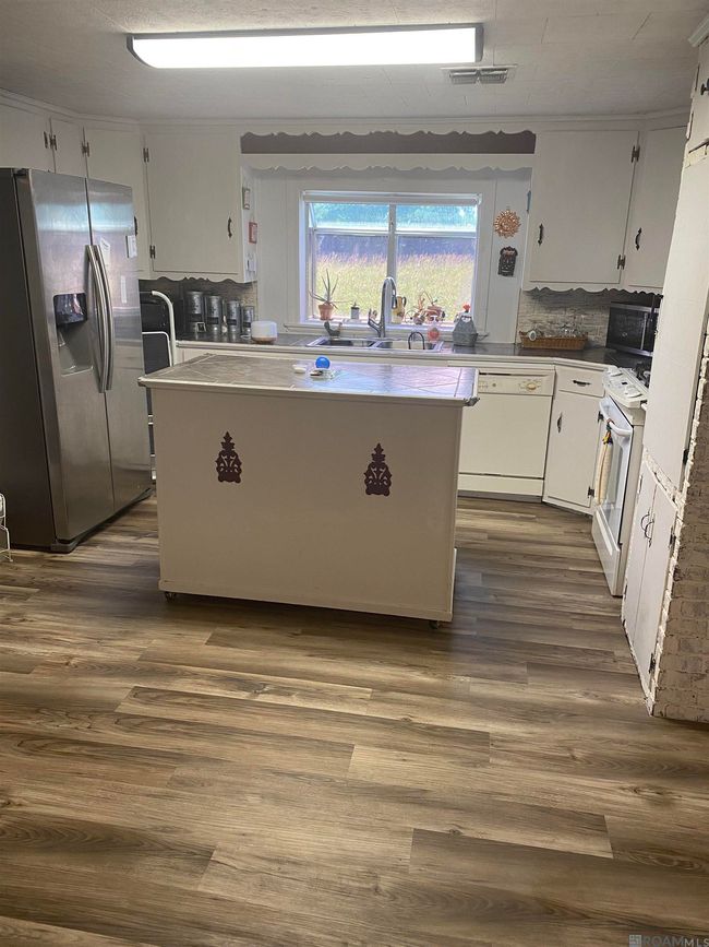Kitchen has a beautiful view and a movable island | Image 5