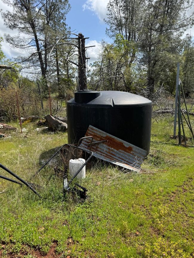 The property has a well with a storage tank and water filter system. | Image 11