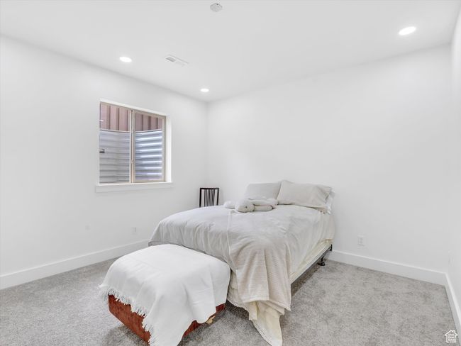 Carpeted bedroom with visible vents, baseboards, and recessed lighting | Image 32
