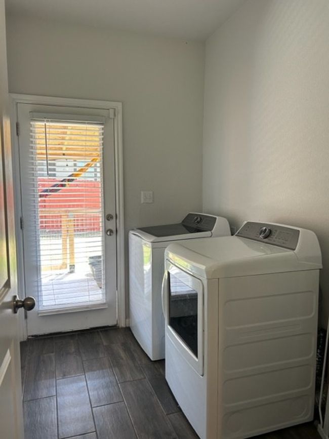 Laundry room featuring independent washer and dryer, laundry area, and wood tiled floor | Image 8