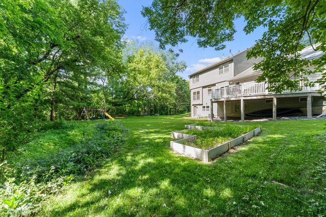 Mature trees provide natural privacy and shade, and the well-maintained front landscaping adds to the home's standout curb appeal. | Image 21