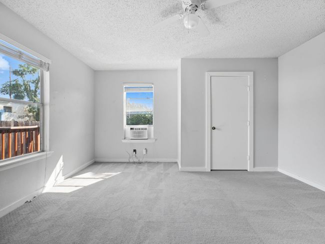 Carpeted spare room with a textured ceiling and a ceiling fan | Image 23